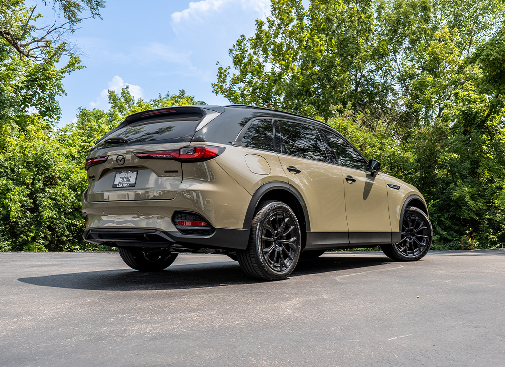 Rear view of a Mazda CX-70 SUV with a roof wrap and accessories.