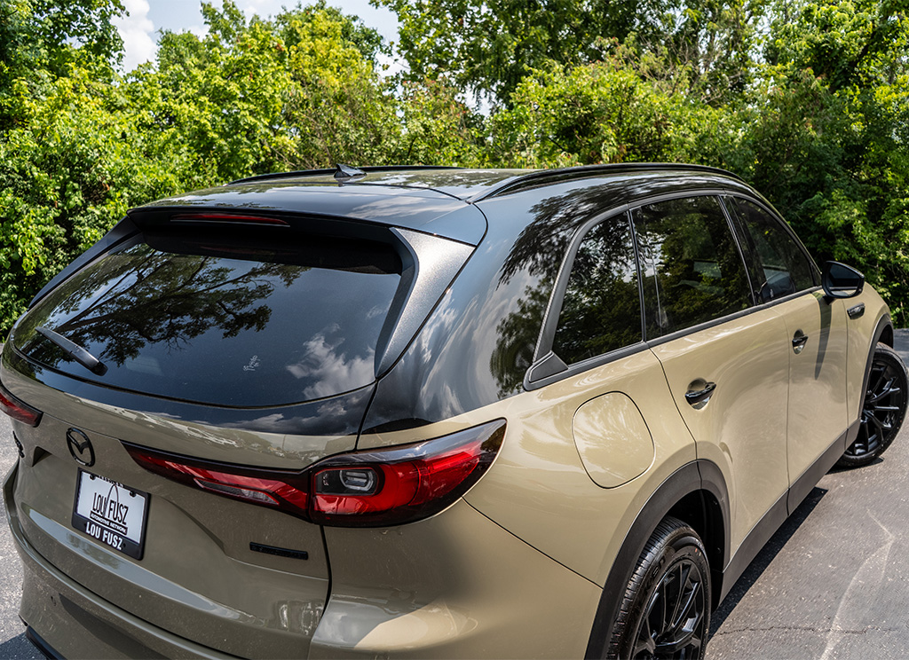 Close-up of a black vinyl roof wrap on a Mazda CX-70 SUV.