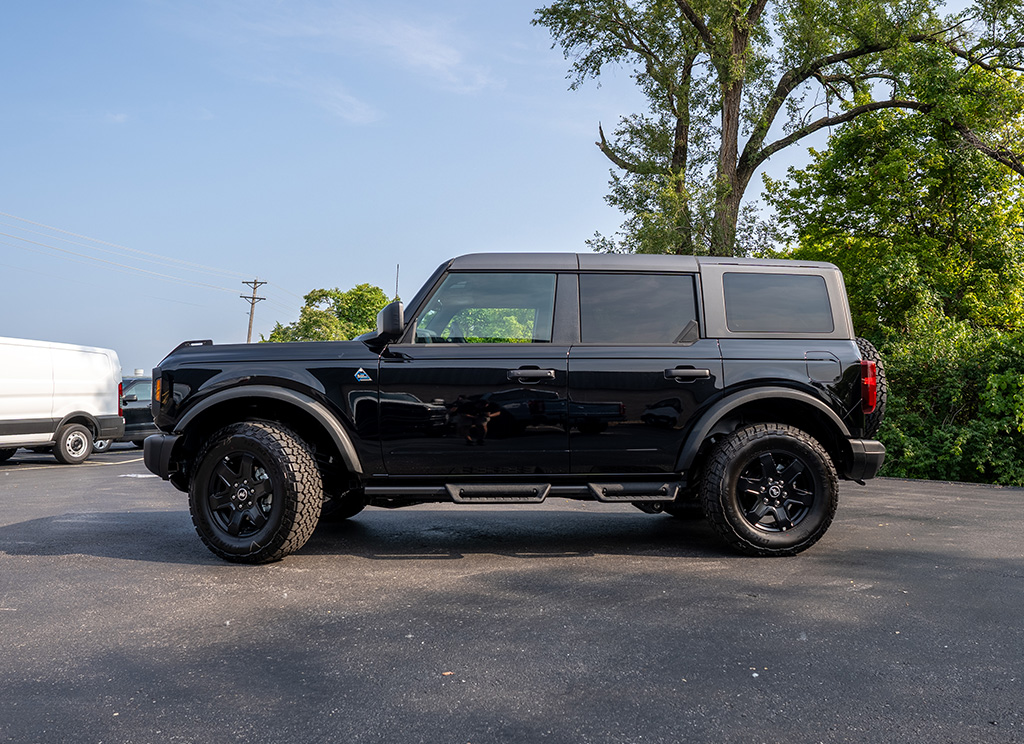 Side profile of a stock 2024 Black Ford Bronco SUV.