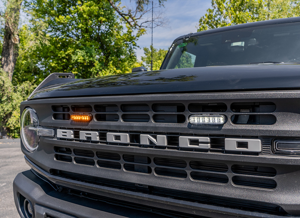 Whelen amber and white LED lights installed on a Bronco grille.