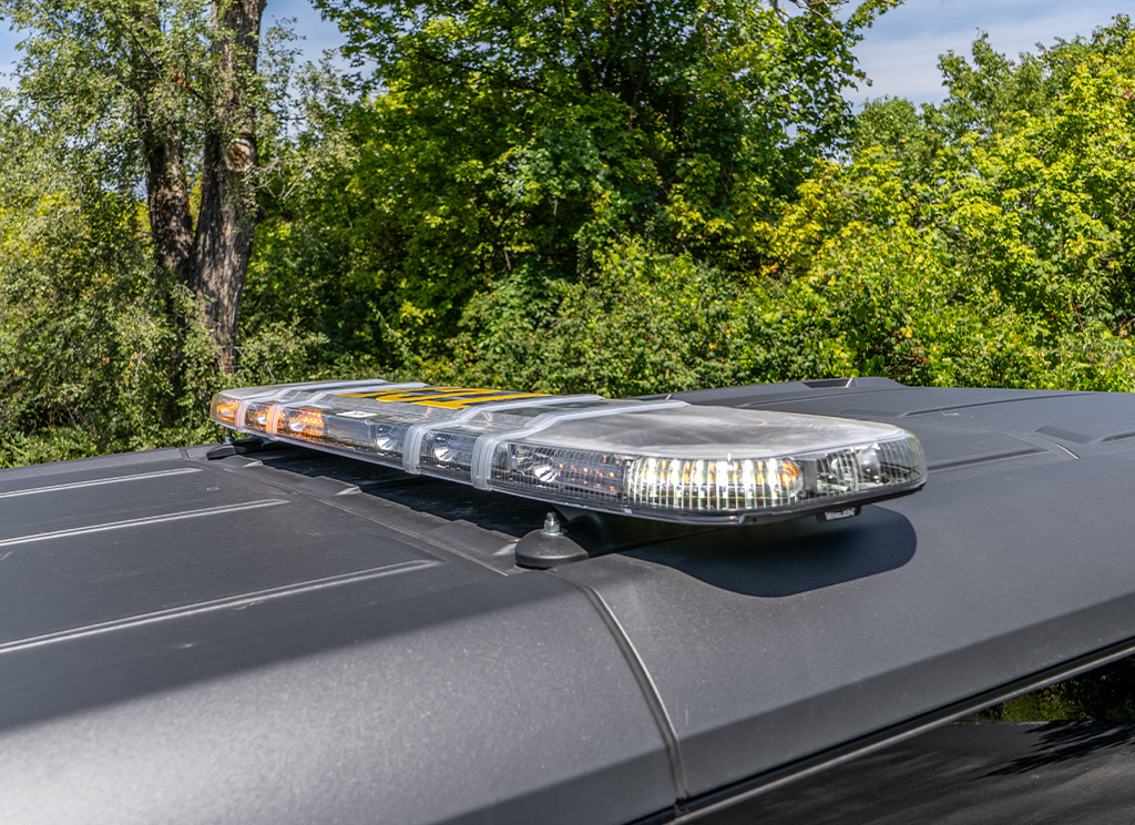 Whelen Cenator amber and white LED light bar on the roof of a Ford Bronco security vehicle.