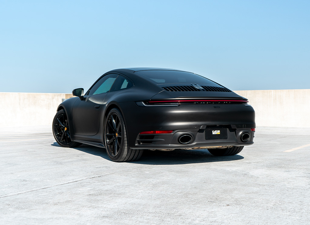 Rear view of a custom matte black Porsche 911.