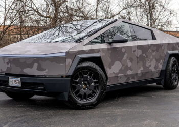 Full view of a Tesla Cybertruck with a gray camouflage printed vinyl wrap.