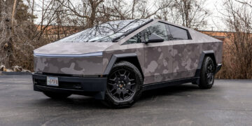 Full view of a Tesla Cybertruck with a gray camouflage printed vinyl wrap.