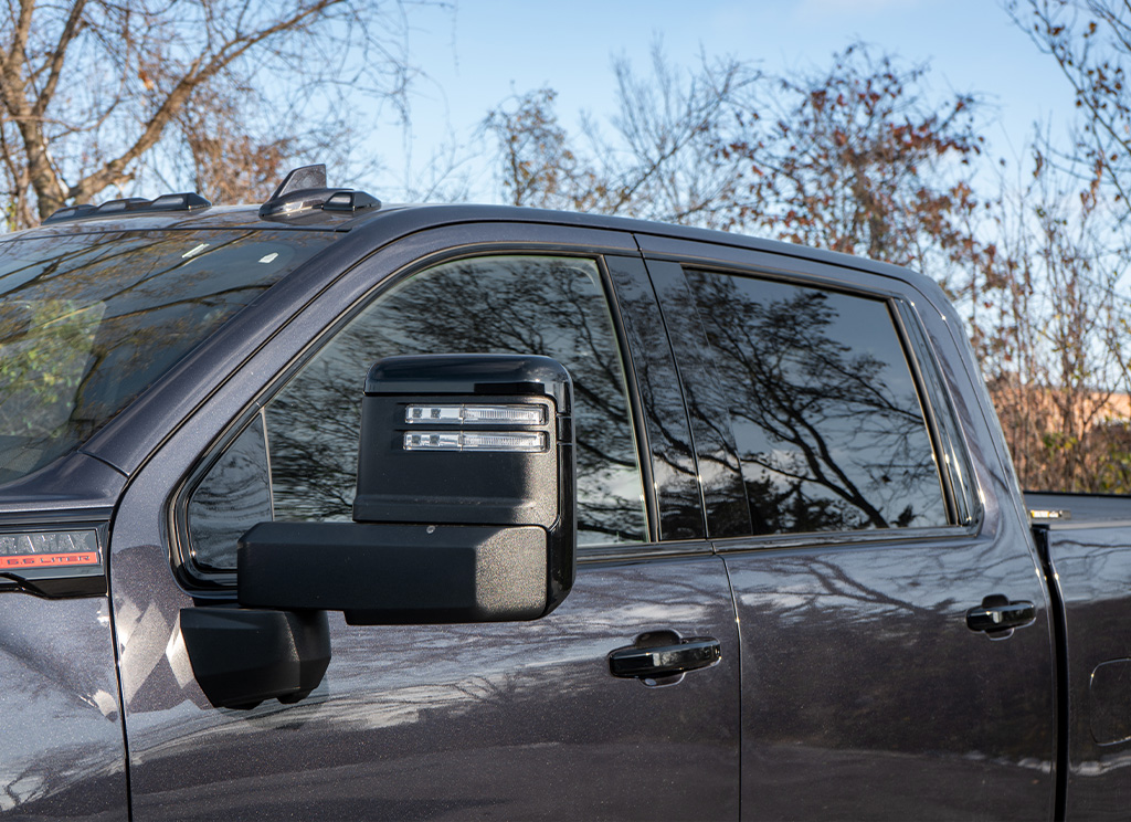 Black window trim and mirror caps on a 2024 GMC Sierra HD3500 Denali truck.