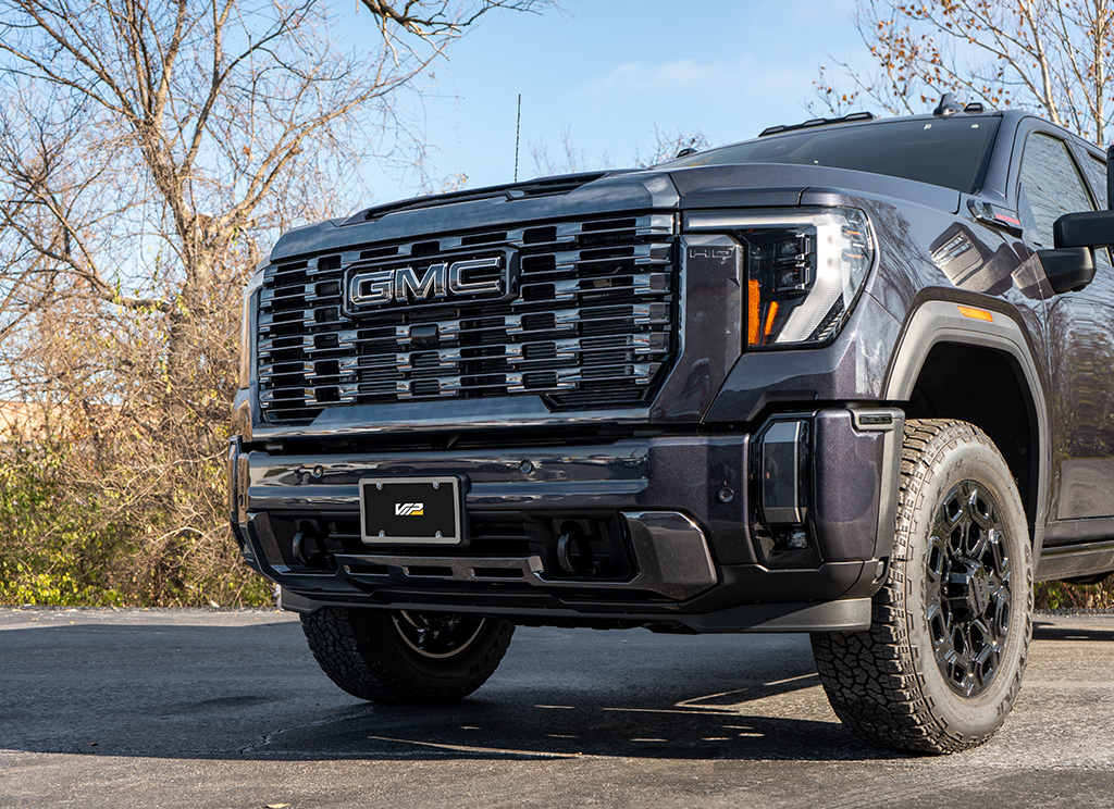 Close-up of a Vader chrome grille and front bumper trim on a 2024 GMC Sierra HD 3500 truck.