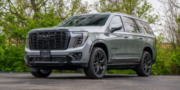 Full view of a Sterling Metallic Grey 2025 GMC Yukon Denali with custom black chrome delete trim.