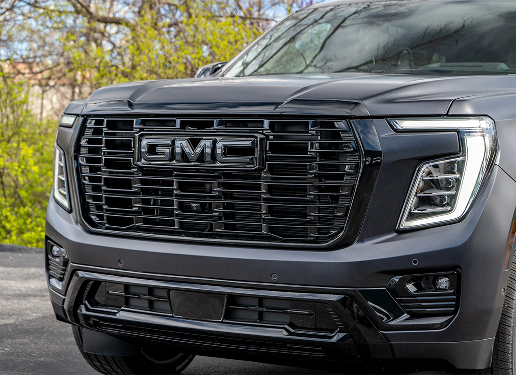 Black grille and front bumper of a 2025 GMC Yukon Denali Blackout build.