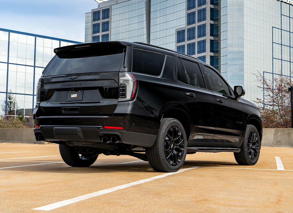 Rear view of a custom blackout 2025 Chevy Tahoe with chrome delete trim and accents.