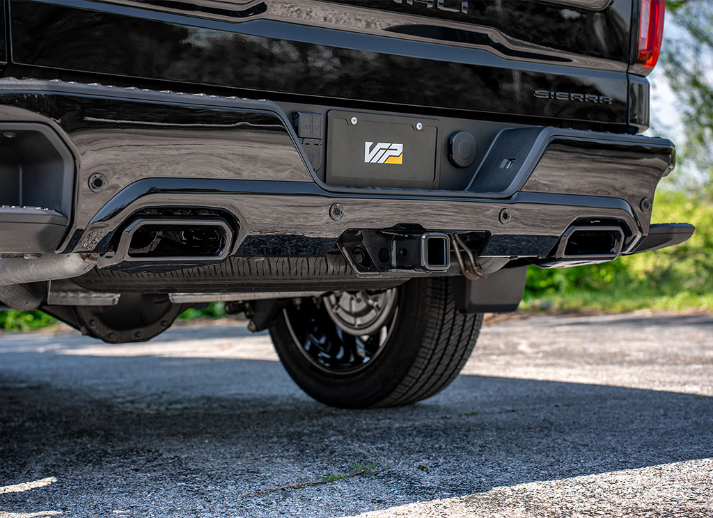 Close-up of a black GMC Sierra 1500 Chrome Delete Rear Bumper.