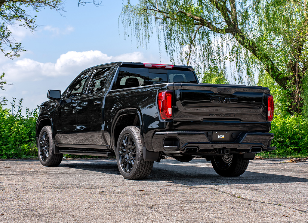 Rear angle view of a custom blackout GMC Sierra 1500 truck.