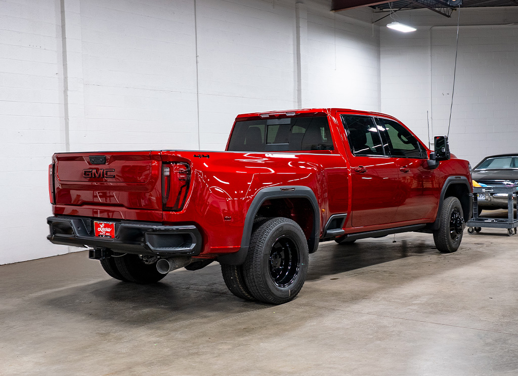 Rear view of a custom 2025 GMC Sierra HD with black chrome delete trim.