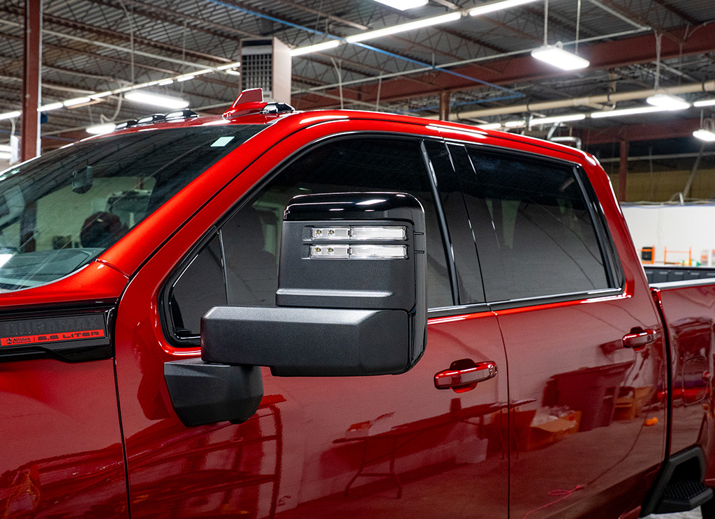 Black 2025 GMC Sierra HD window trim and mirror caps.