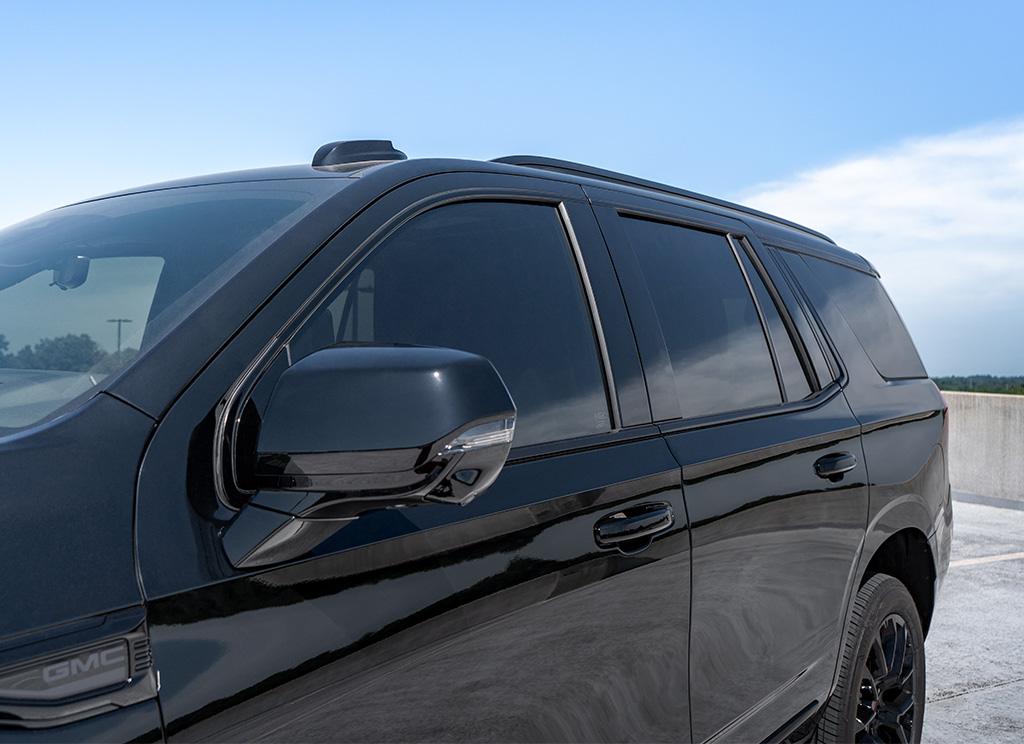 GMC Yukon Denali with black window moldings, roof rails, door handles, and more.