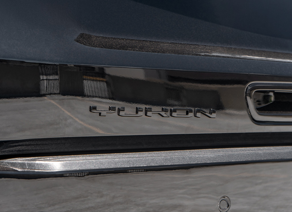 Close-up of a black Yukon badge on the rear tailgate of a 2025 GMC Yukon Denali.