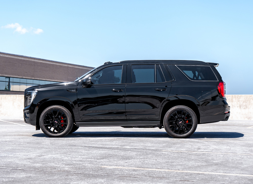 Side profile of a blackout 2025 GMC Yukon Denali that has custom chrome delete trim and other accessories.