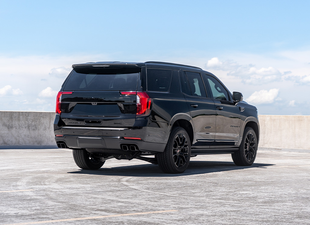 Full rear view of a custom 2025 GMC Yukon Denali with blackout chrome delete trim.