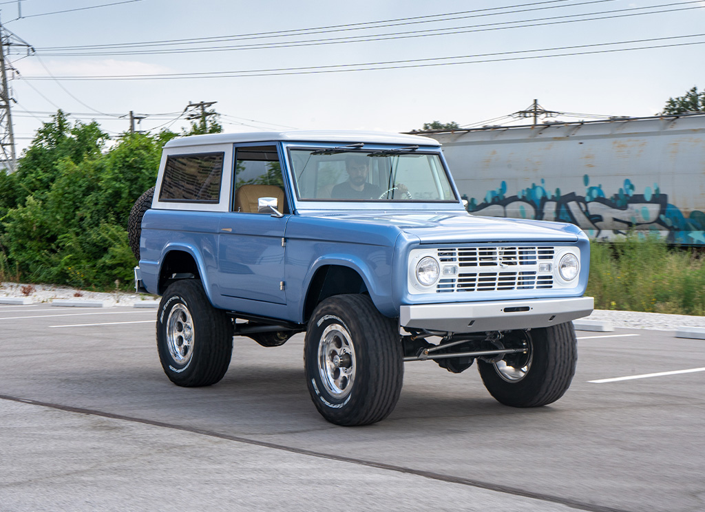 1971 Ford Bronco Restoration driving by a train