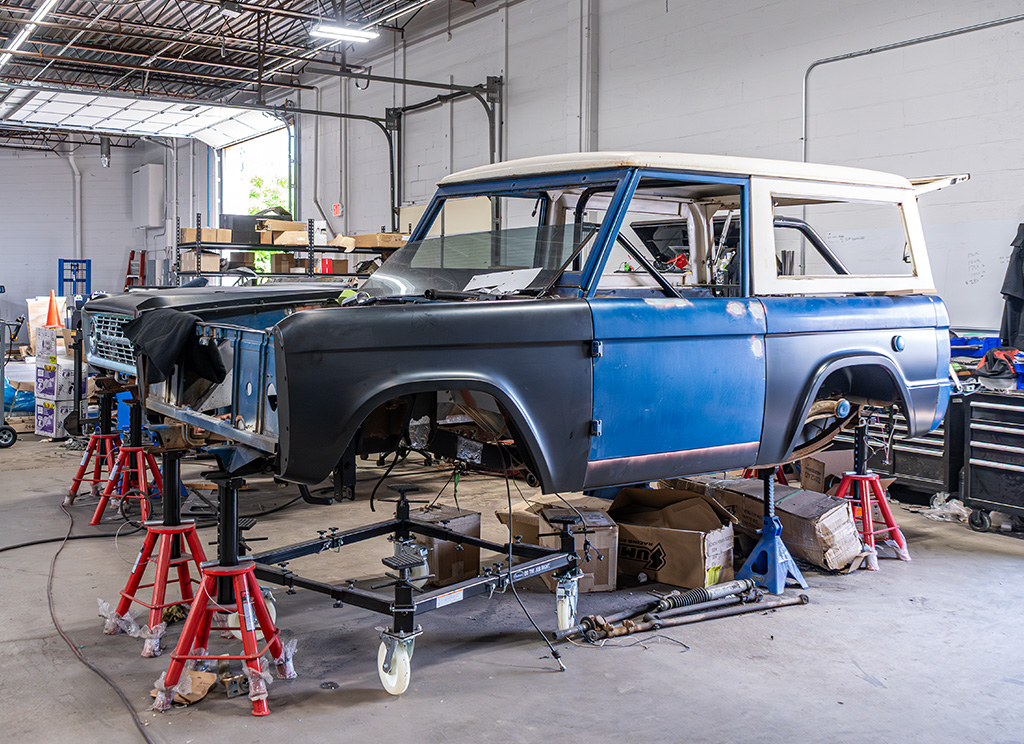 1971 Ford Bronco being restored with new body panels body off of chassis.