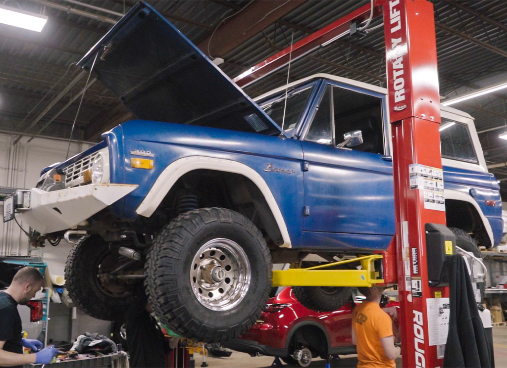 Old Astra Blue 1971 Ford Bronco stock from the factory up on a lift