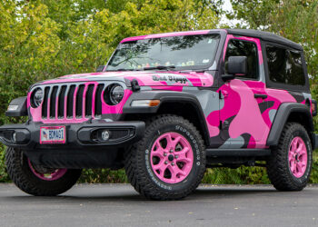 2022 Jeep Wrangler with a pink camo vinyl wrap and pink wheels.