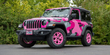 2022 Jeep Wrangler with a pink camo vinyl wrap and pink wheels.