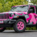 2022 Jeep Wrangler with a pink camo vinyl wrap and pink wheels.