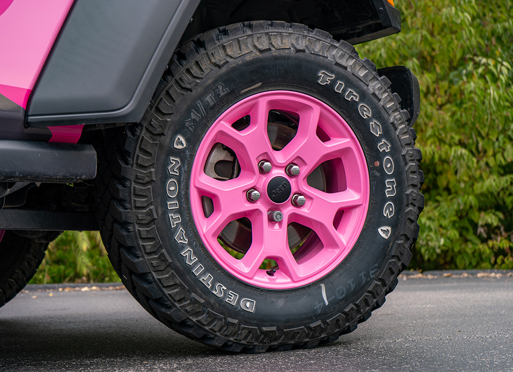 Pink powder coated wheels on a Jeep Wrangler.