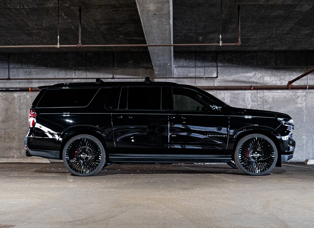 Side profile of a blackout Chevy Suburban with premium chrome delete trim.
