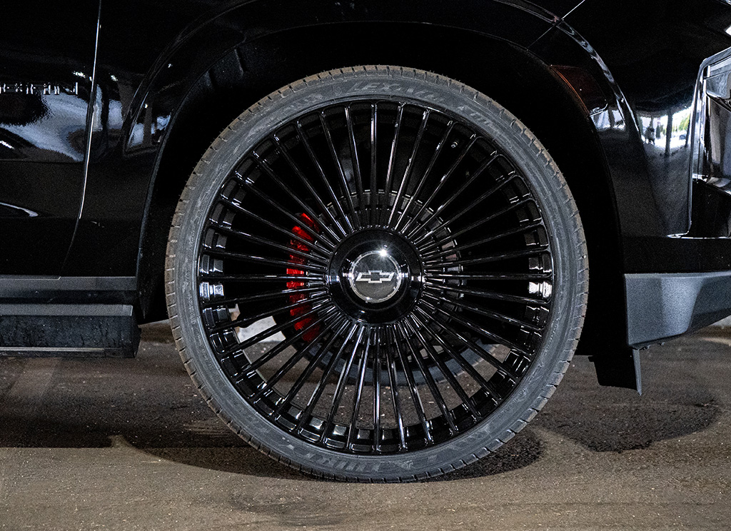 Dolce Luxury Trento 24x10 rims in gloss black with Chevy bowtie center caps.