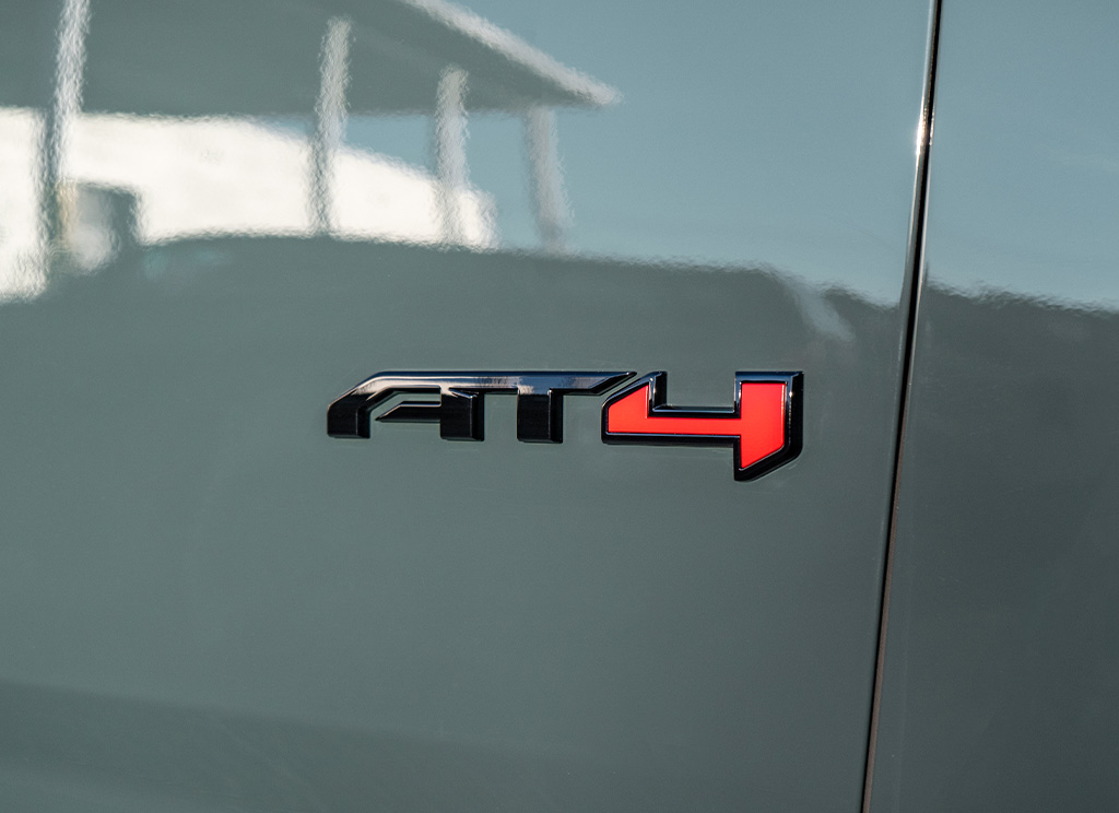 Midnight Pine 2026 GMC Yukon AT4 with custom black AT4 badge.