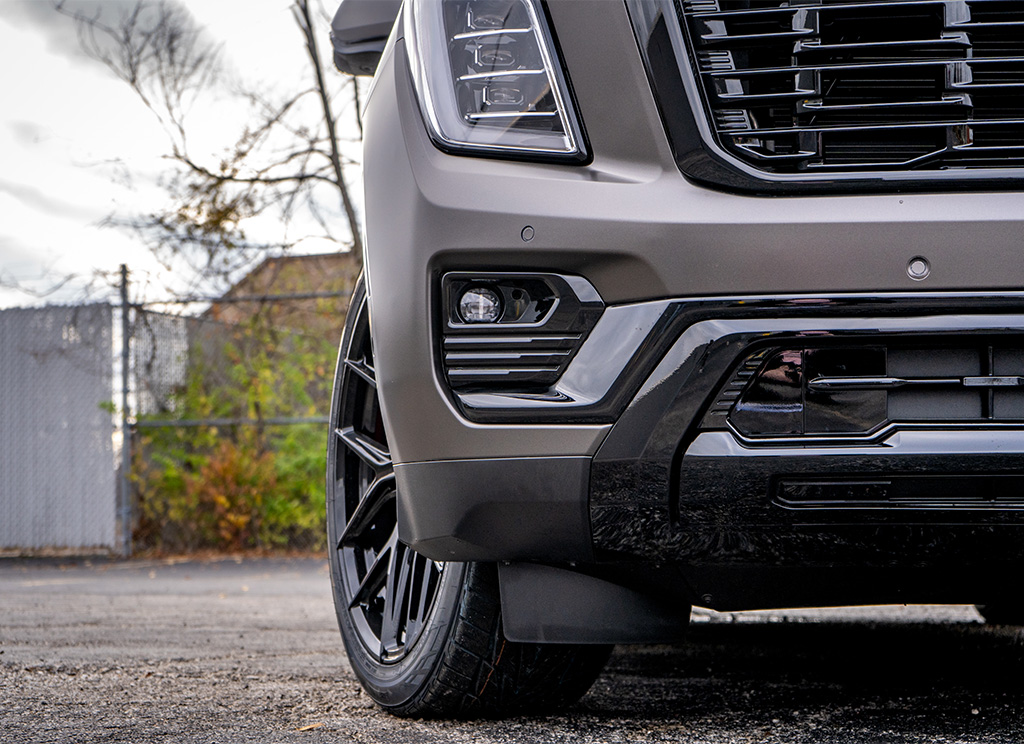 2026 GMC Yukon Denali with black chrome delete grille, fog light bezel molding, and front bumper trim.