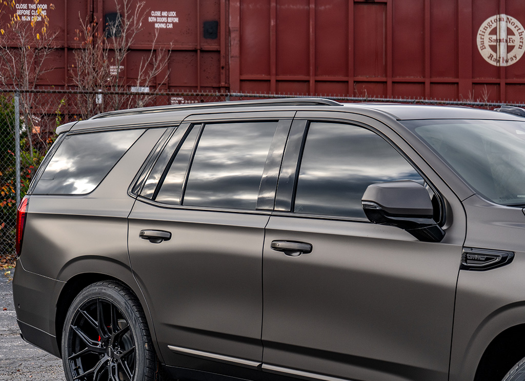 Blackout window molding and tinted windows on a 2026 GMC Yukon Denali with chrome delete trim.