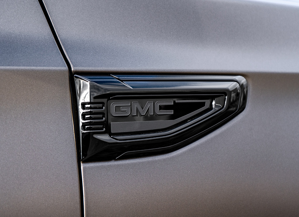 Satin gray 2026 GMC Yukon Denali with black fender vent badge.