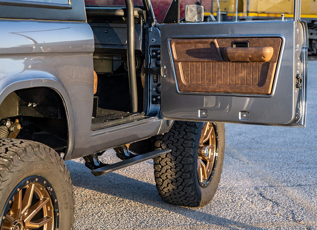 1972 Ford Bronco Restomod - leather door panel and electronic side-steps.