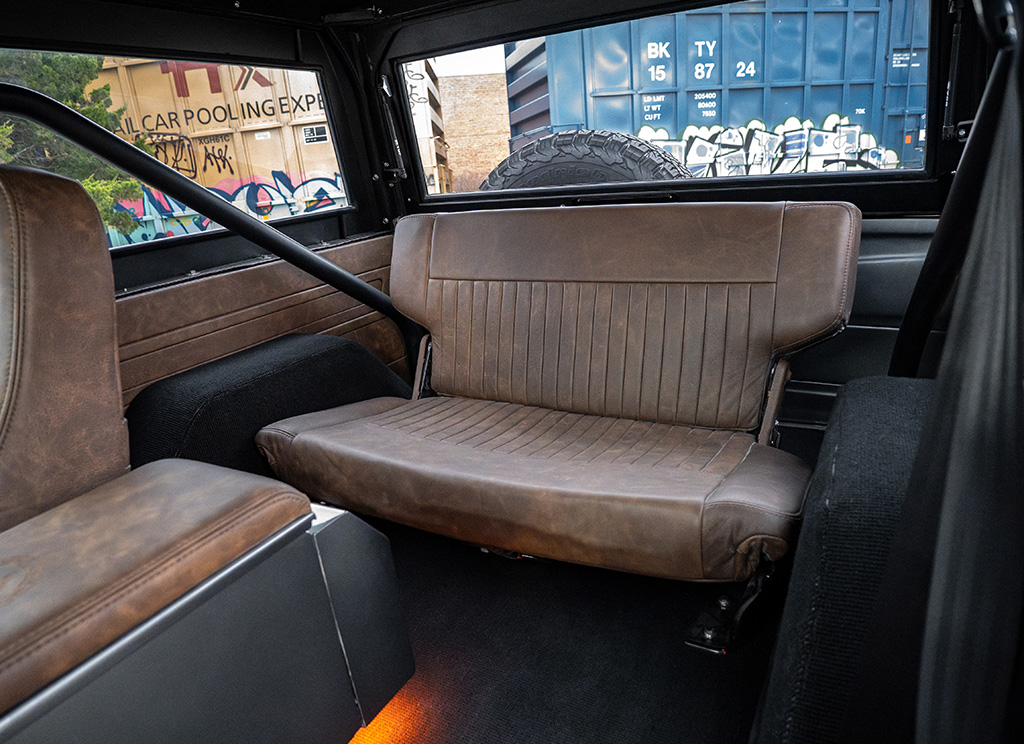 Custom dark brown coffee colored leather interior second row rear bench seat in a restored 1972 Ford Bronco.
