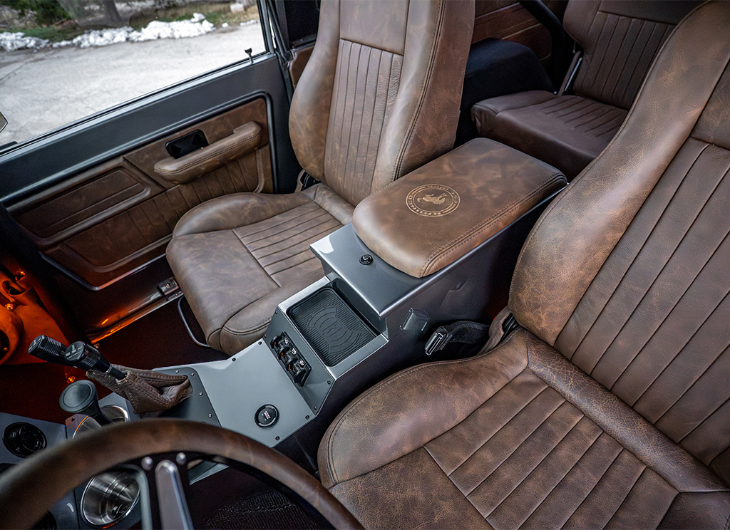 1972 Ford Bronco Restoration - custom center counsel design with wireless charger, brown leather seats, and push to start.