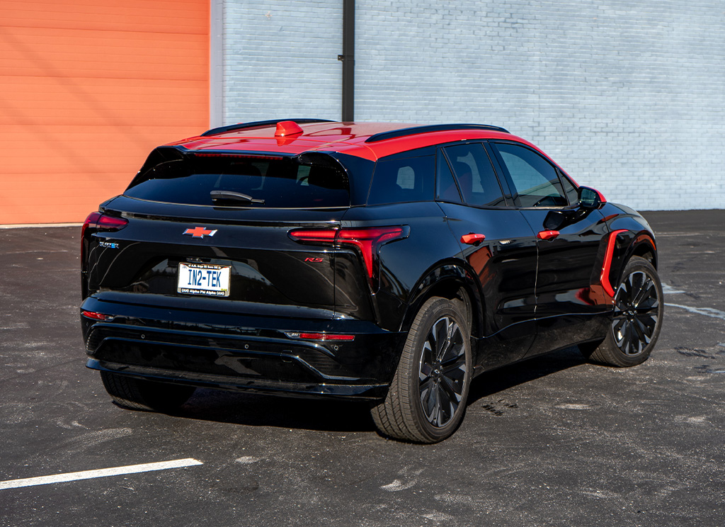 Rear view of a red a and black 2025 Chevy Blazer EV.