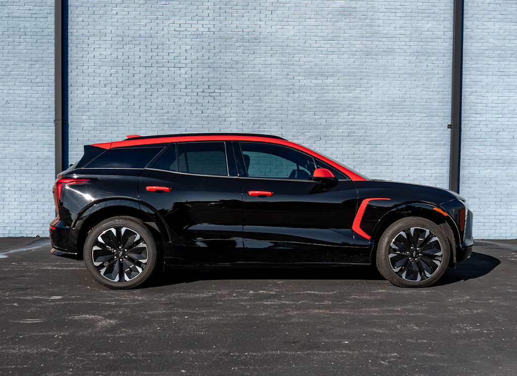 Side profile of custom 2025 Chevrolet Blazer EV with a red roof wrap.