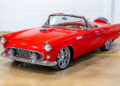 Restored 1956 Ford Thunderbird restomod with red paint and custom convertible top.
