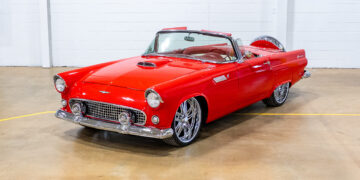 Restored 1956 Ford Thunderbird restomod with red paint and custom convertible top.