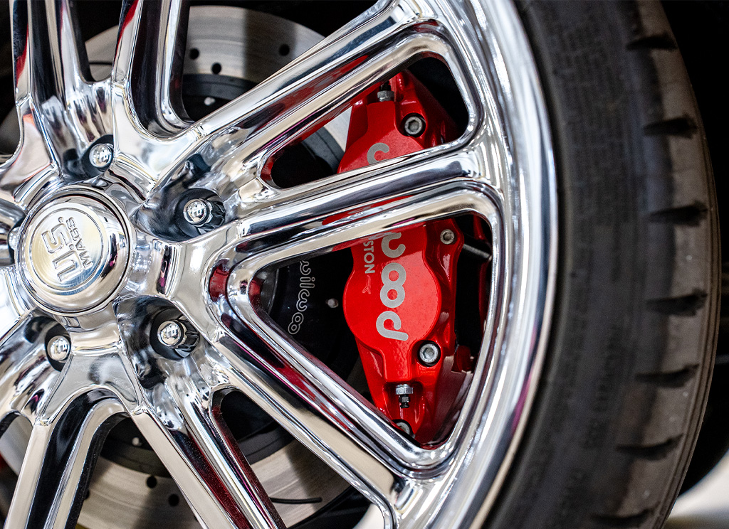 Close-up of Wilwood brakes behind new chrome wheels.