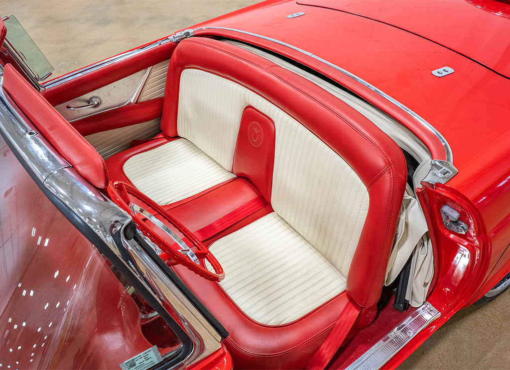 Custom red and white leather bench seat in a 1956 Ford Thunderbird restoration.