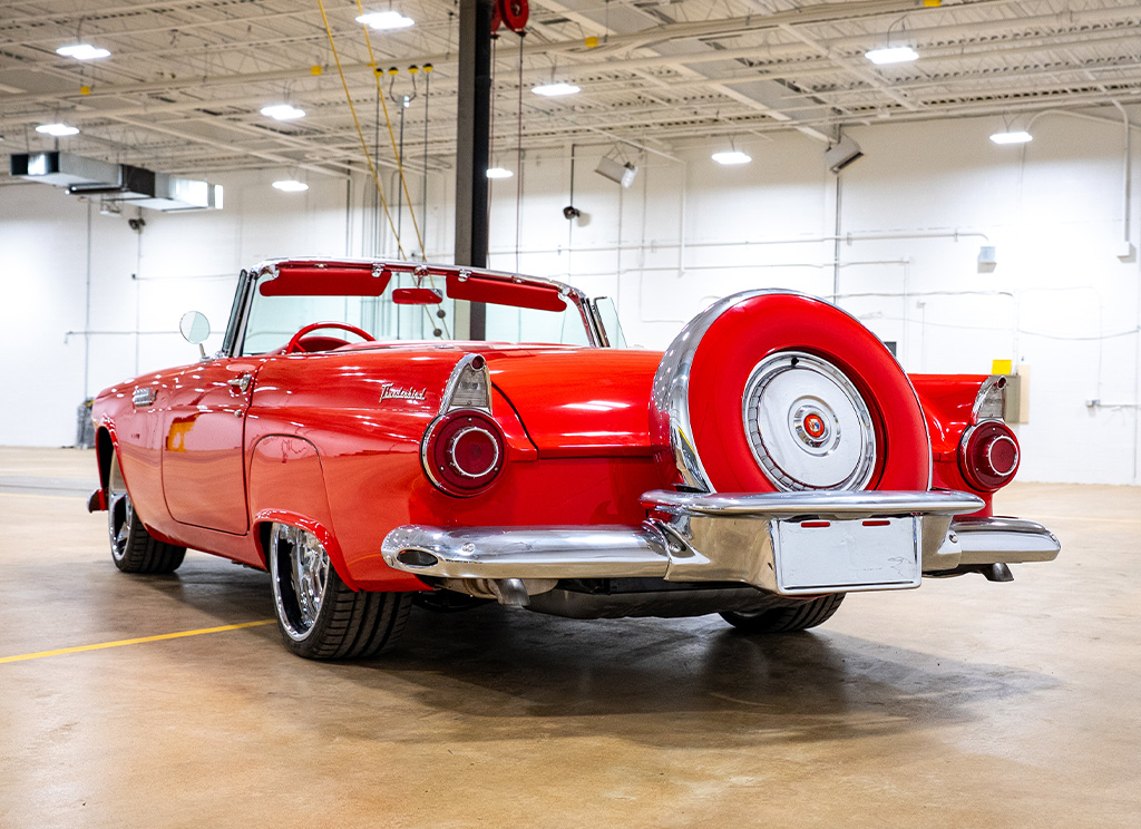 Rear hero image of a red 1956 Ford Thunderbird restoration.