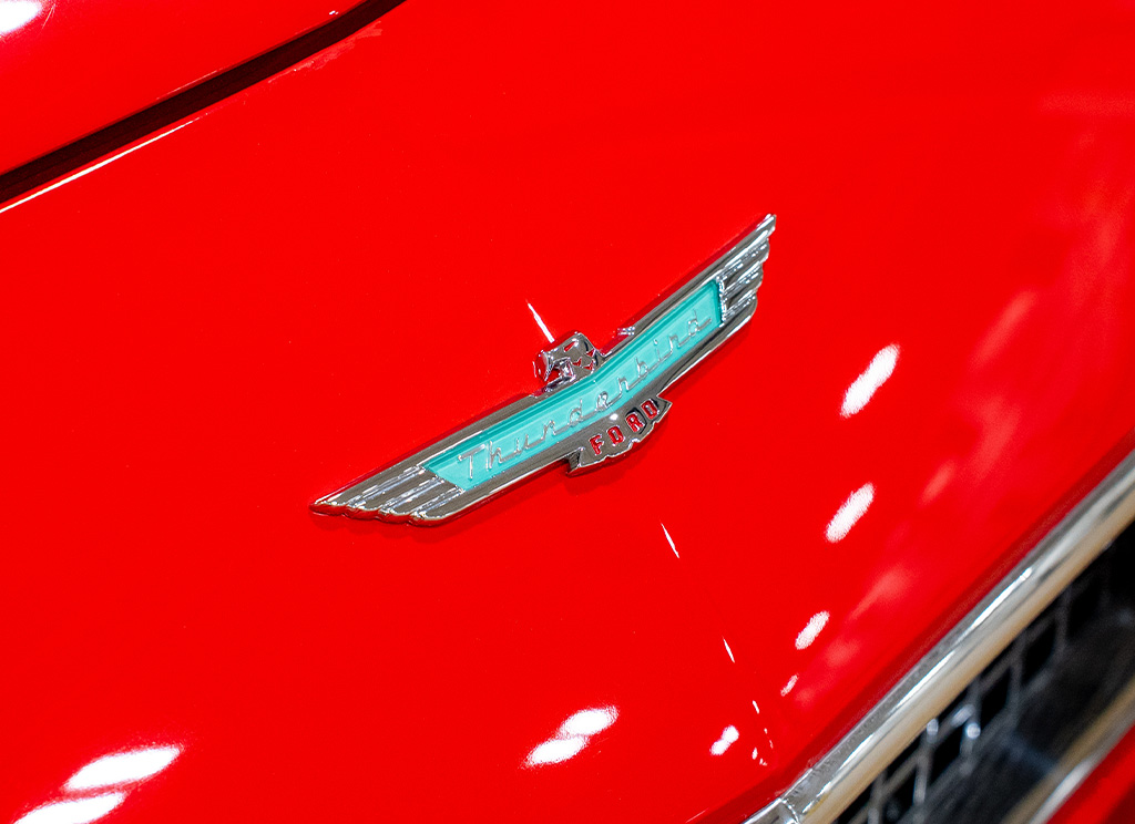 New 1956 Ford Thunderbird emblem on red paintjob.