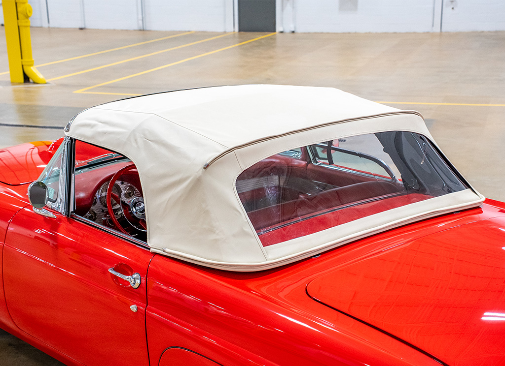 Close-up of a khaki convertible top on a custom red 1956 Ford Thunderbird restoration.