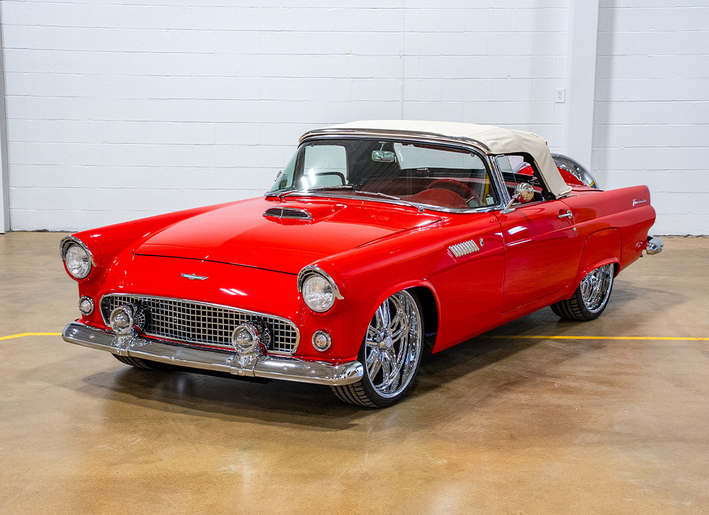 Custom red 1956 Ford Thunderbird restoration with a khaki convertible soft top up.