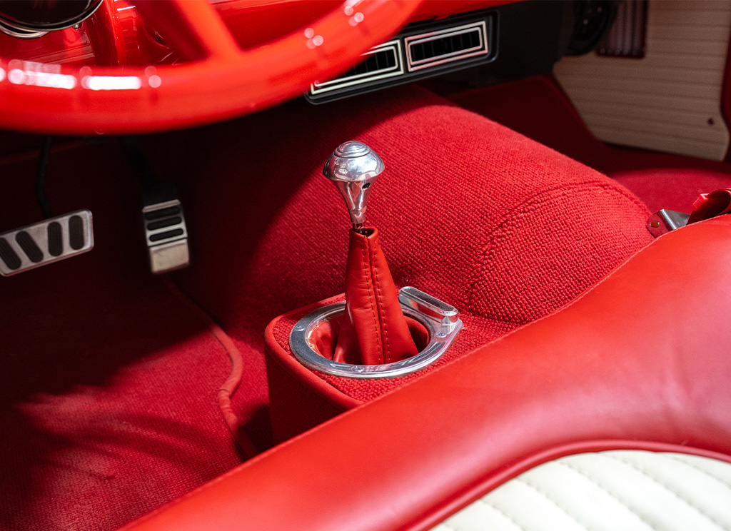 Fresh new red carpeting in a 1956 Ford Thunderbird after getting restored.