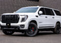 White 2026 GMC Yukon Denali with blackout chrome delete trim and custom accessories.