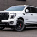White 2026 GMC Yukon Denali with blackout chrome delete trim and custom accessories.